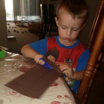 With a combination of scissor practice and tearing, Tahoe cut out pieces of brown construction paper for the project.